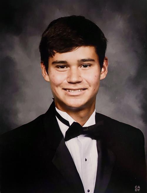 A teenage boy in a tuxedo